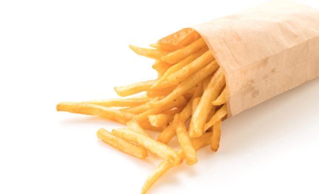 Golden French fries potatoes on white